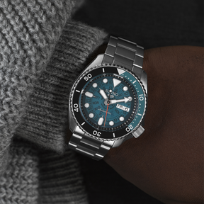 Model wears Seiko 5 Sports SKX 'Skeleton Style', Blue Dial with Stainless Steel Bracelet - SRPJ45K1