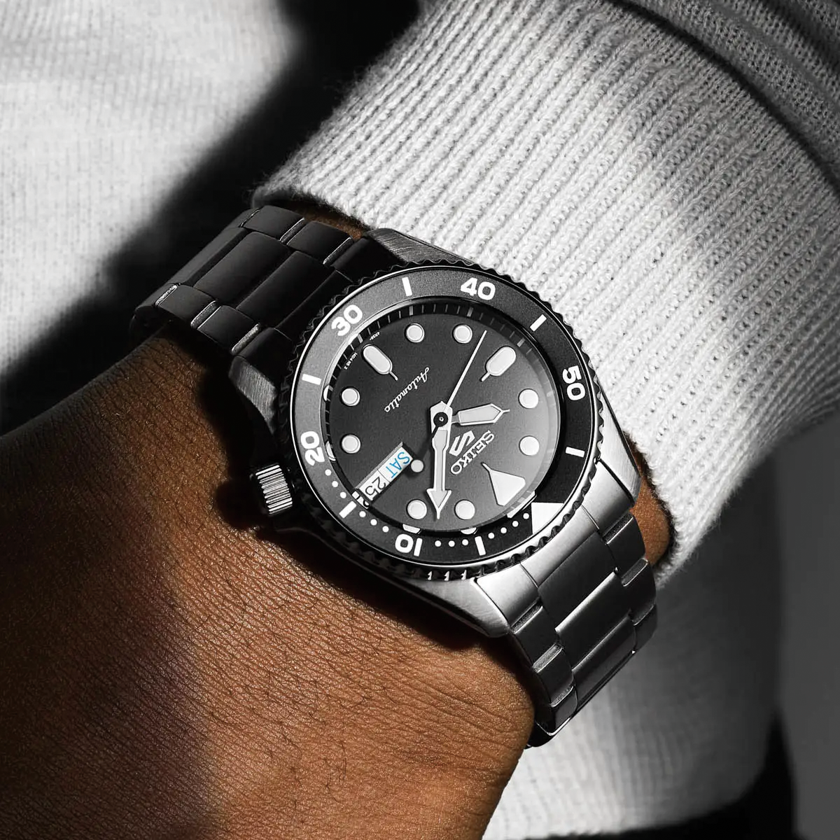 Model wears Seiko 5 Sports SKX “Midi”, Black Dial with Stainless Steel Bracelet - SRPK29K1