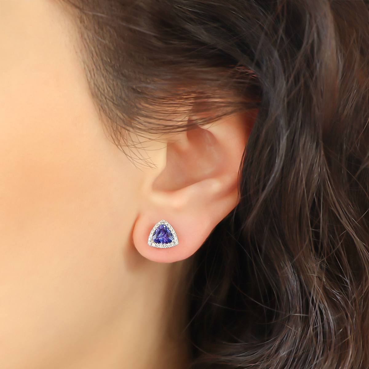 Model wears 18ct White Gold Tanzanite & Diamond Trilliant Halo Earrings