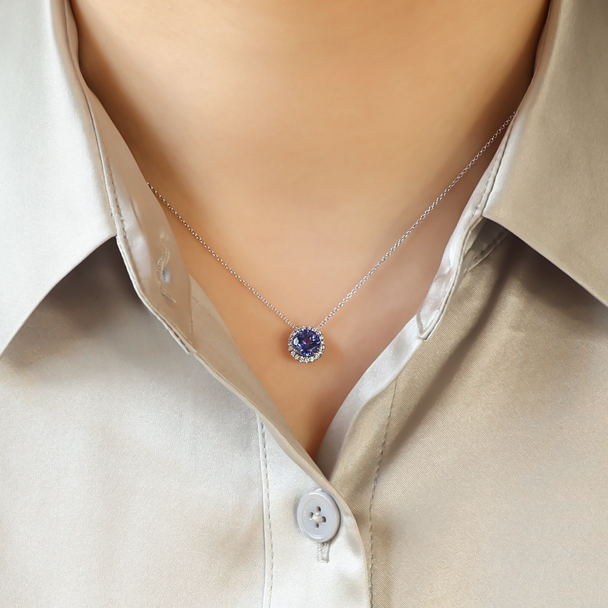 Model wears 18ct White Gold Tanzanite & Diamond Round Halo Pendant