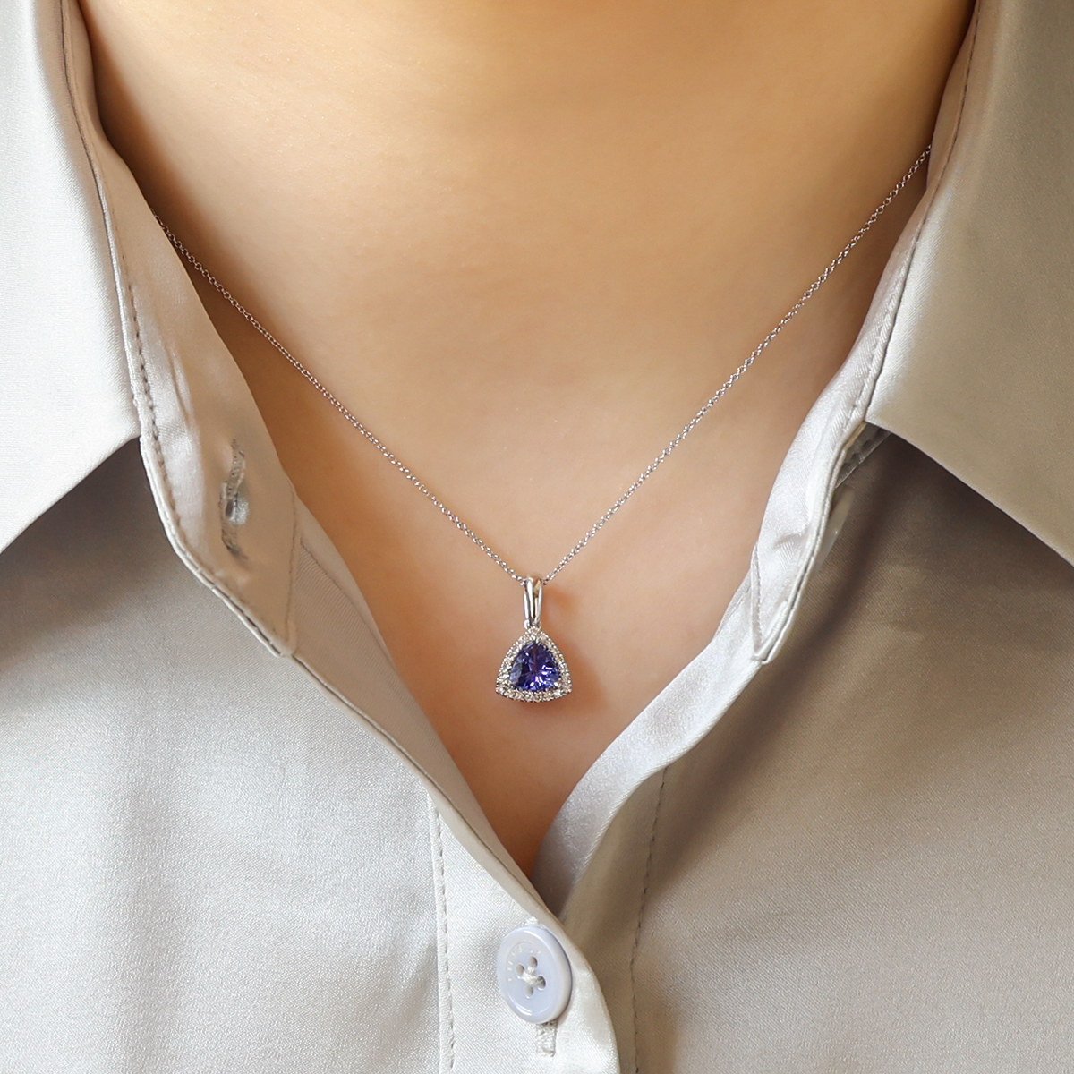 Model wears 18ct White Gold Tanzanite & Diamond Trilliant Halo Pendant