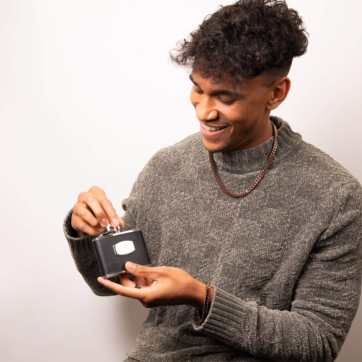 Model holding Fred Bennett Black Leather & Stainless Steel Hip Flask