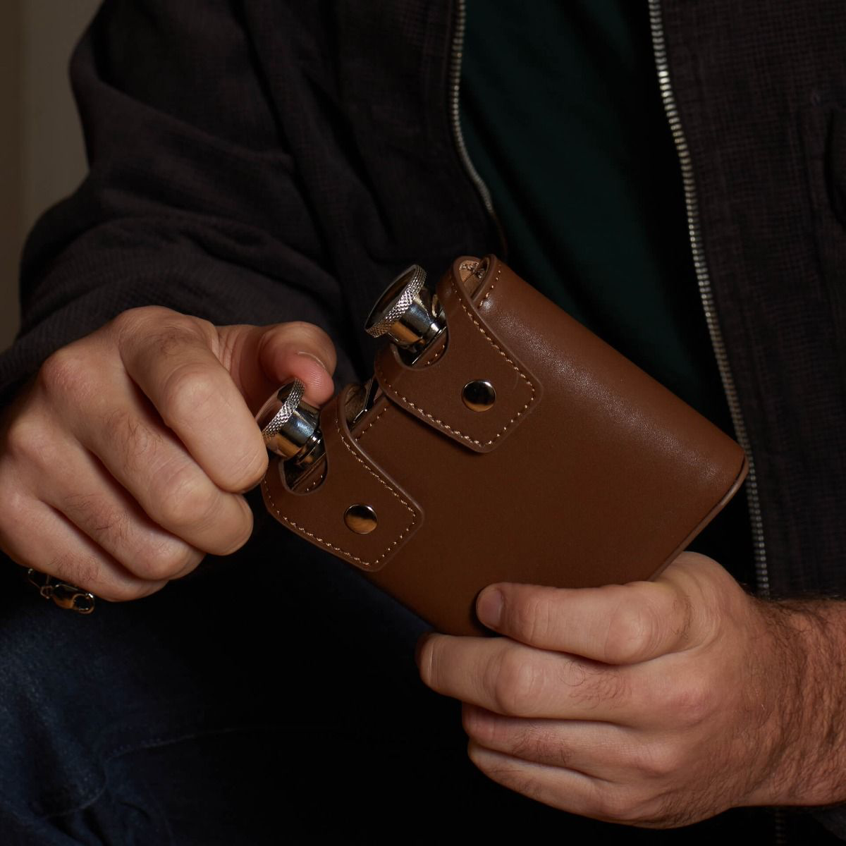Model holds Stainless Steel & Brown Leather Twin 3oz Hip Flasks with Case