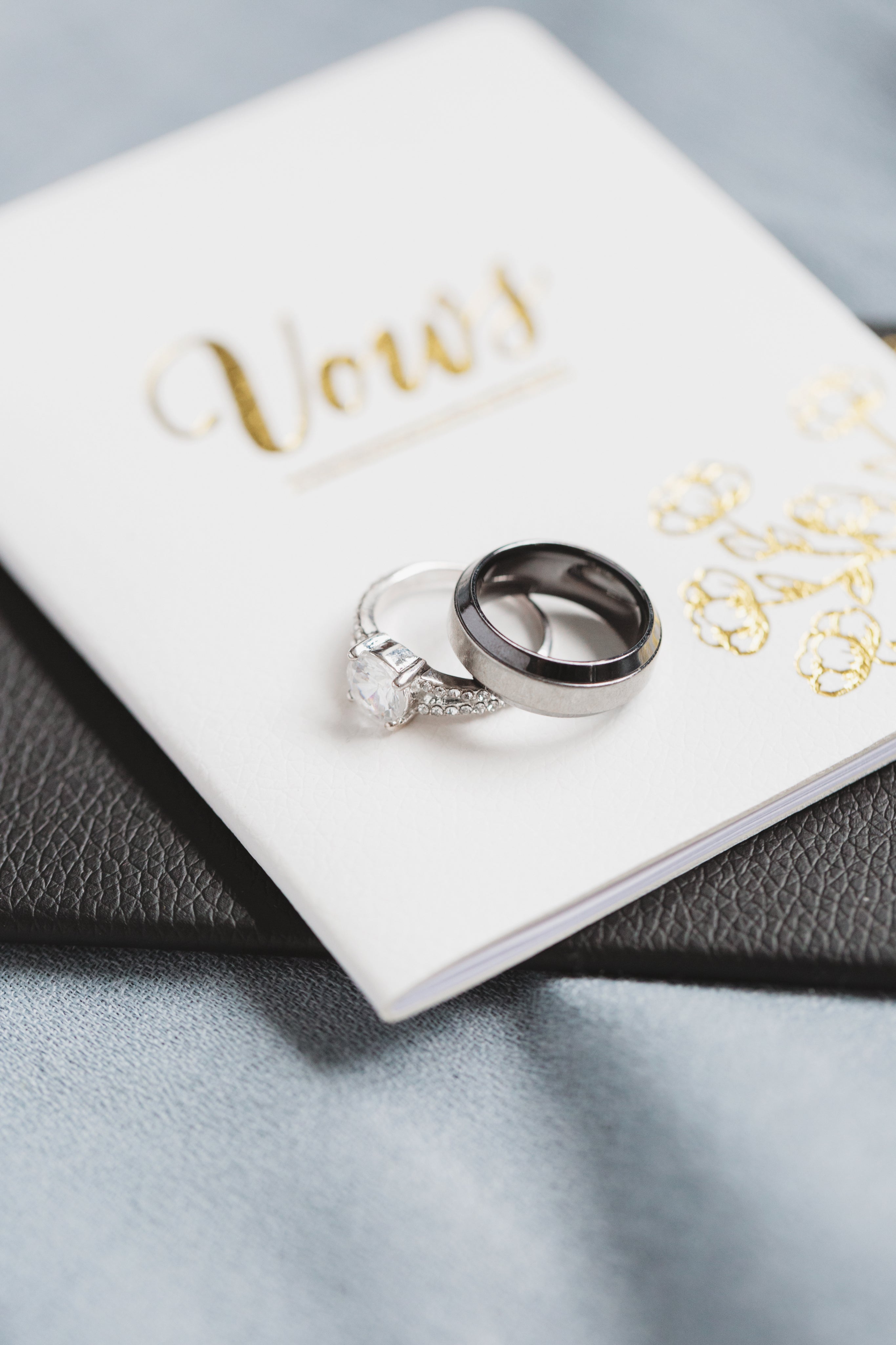 Engagement and wedding ring placed onto of vows.