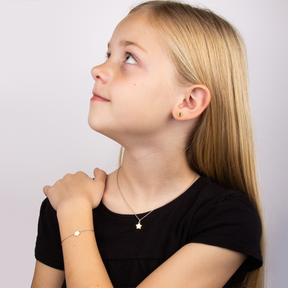 Model wears Recycled Sterling Silver Star Earrings, Bracelet & Necklace With Yellow Gold Plated Detail & Diamond