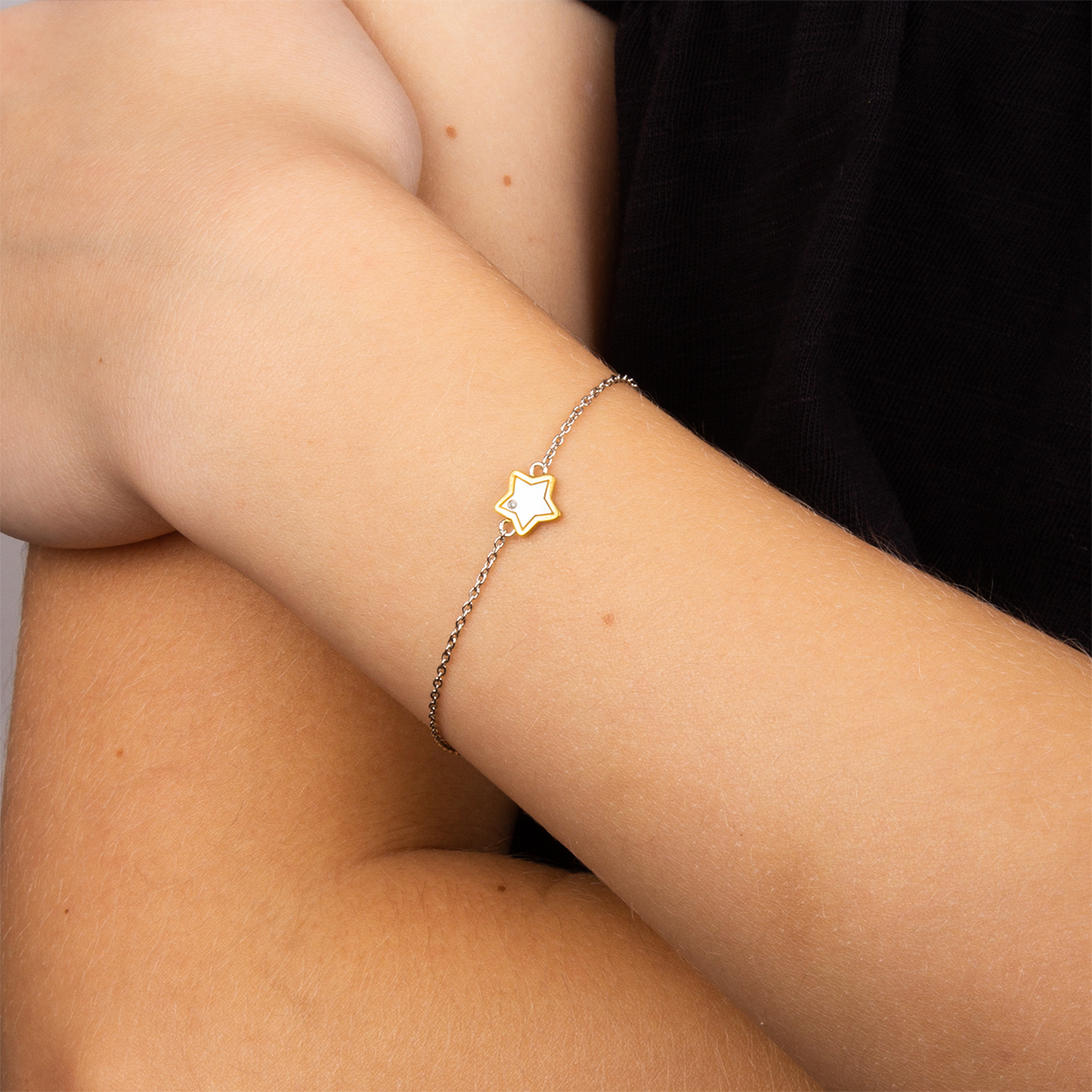 Model wears Recycled Sterling Silver Star Bracelet with Yellow Gold Plated Detail & Diamond