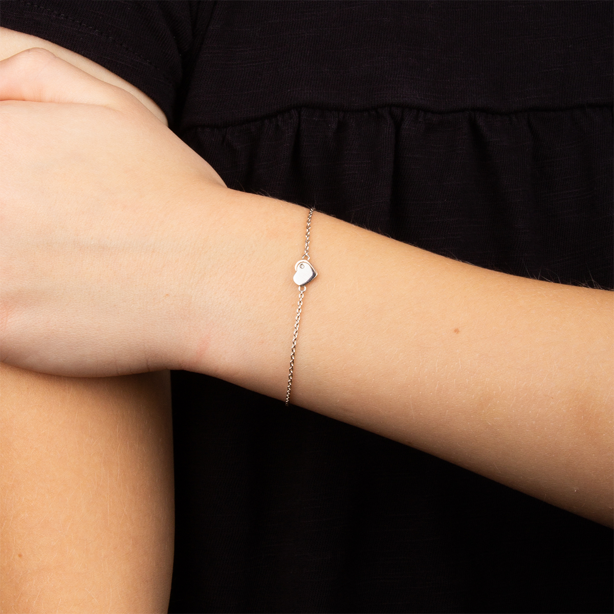 Model wears Recycled Sterling Silver Heart Bracelet with Rose Gold Plated Detail & Diamond