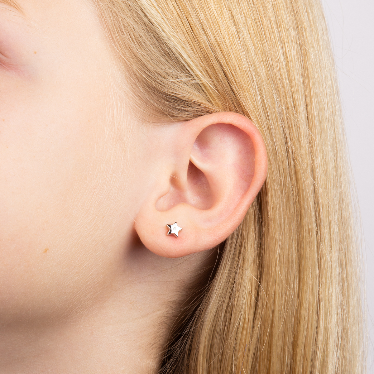 Model wears Sterling Silver Star Stud Earrings With Diamond
