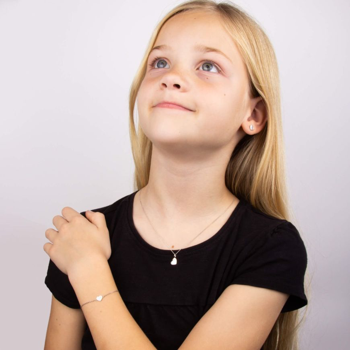 Model wears Recycled Sterling Silver Heart Earrings, Bracelet & Necklace With Rose Gold Plated Detail & Diamond