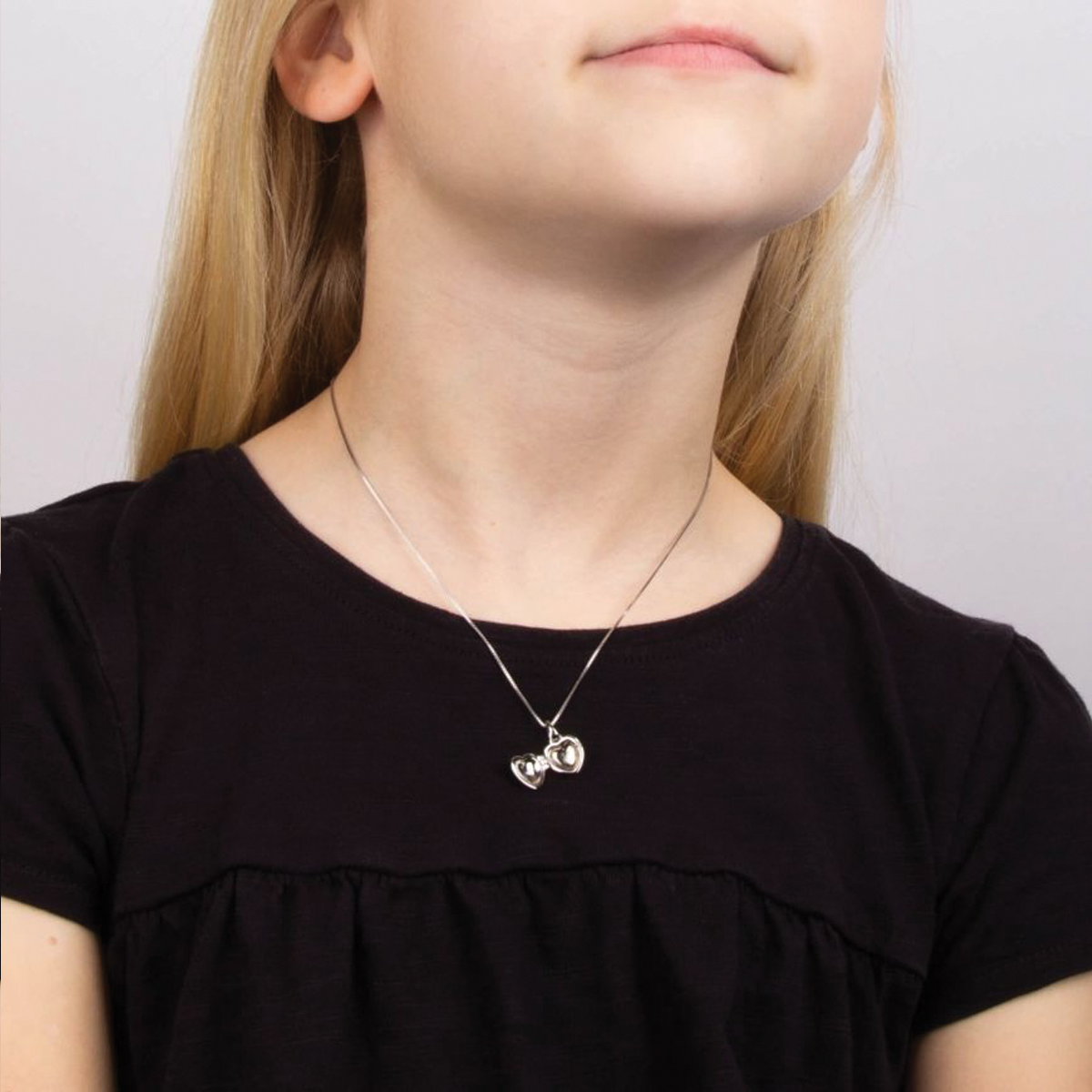 Model wears Sterling Silver Diamond Heart Shaped Locket Pendant With Chain