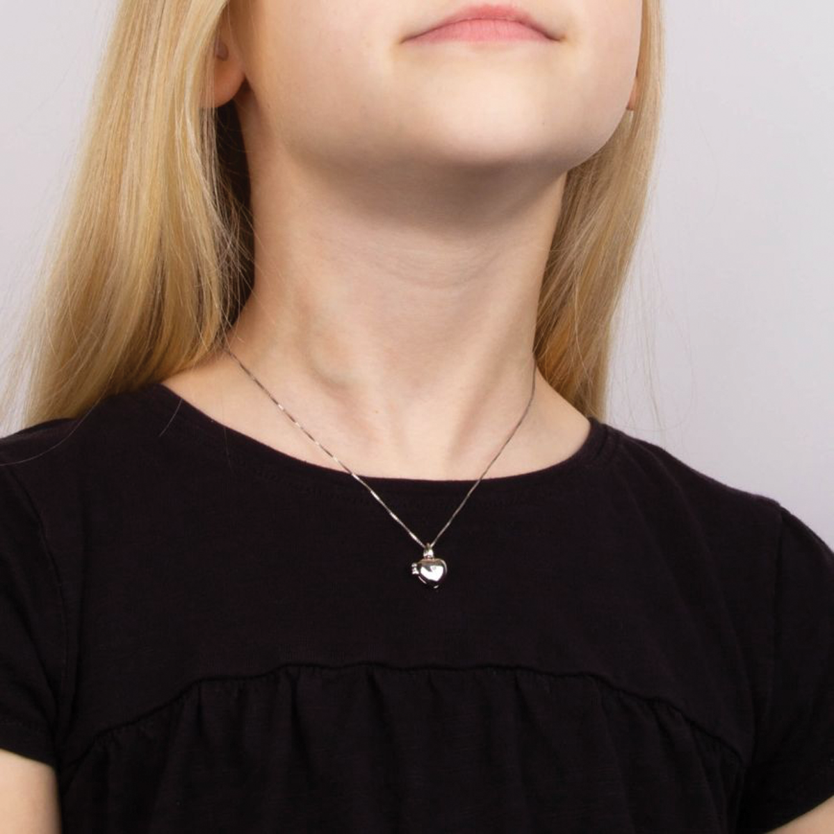 Model wears Sterling Silver Diamond Heart Shaped Locket Pendant With Chain