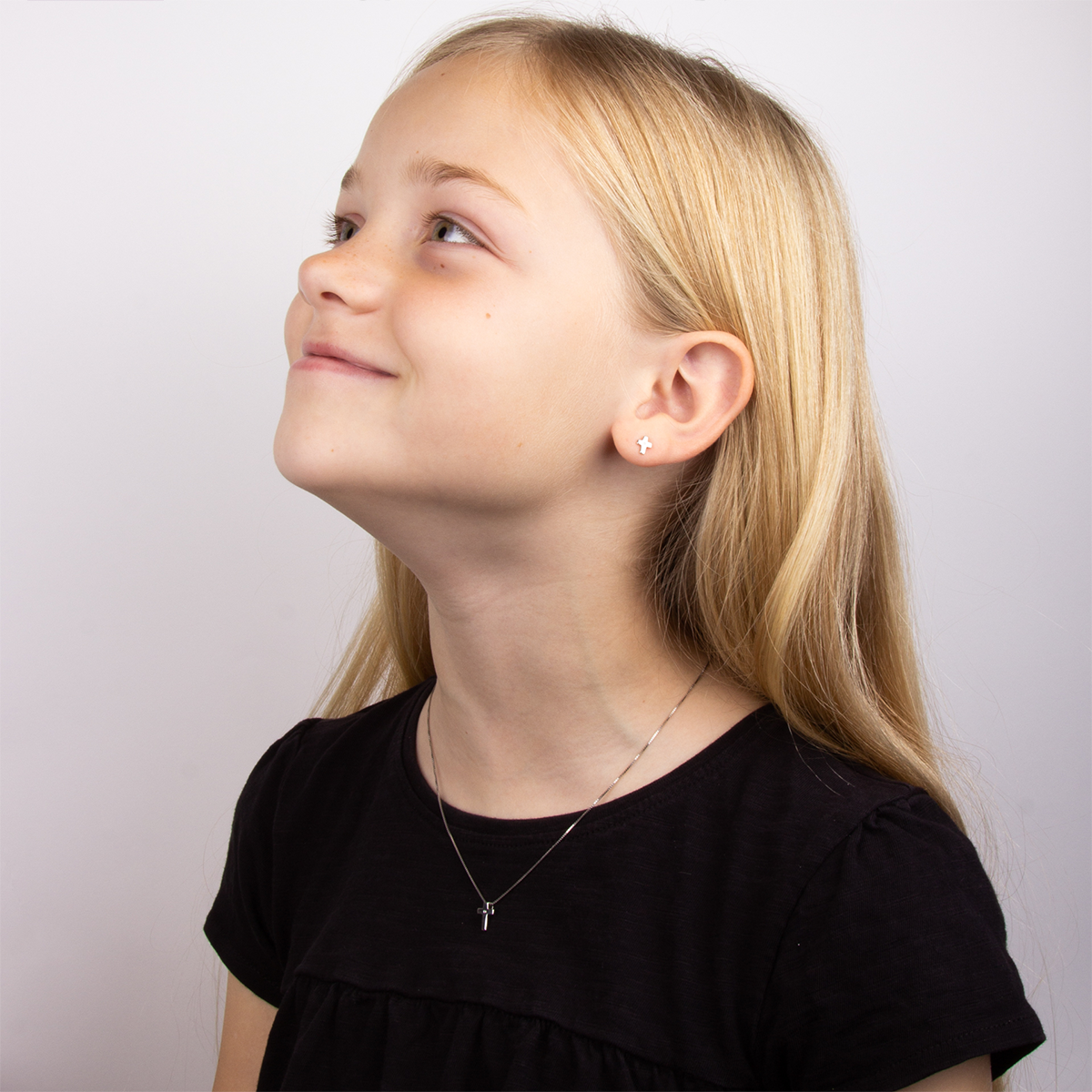 Model wears Sterling Silver Diamond Small Cross Pendant With Chain