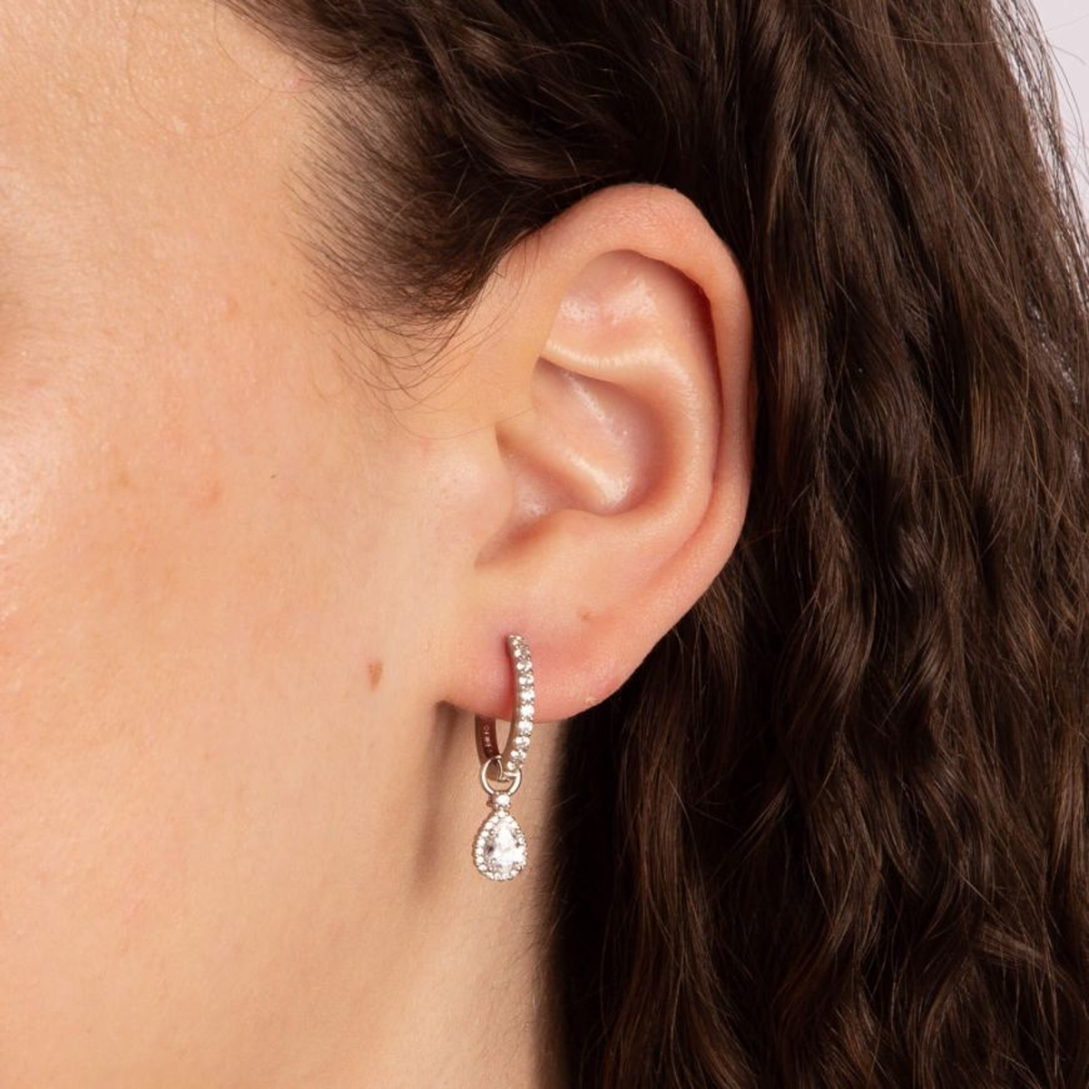 Models wears Sterling Silver Teardrop Cubic Zirconia With Pave Detail Hoop Earrings