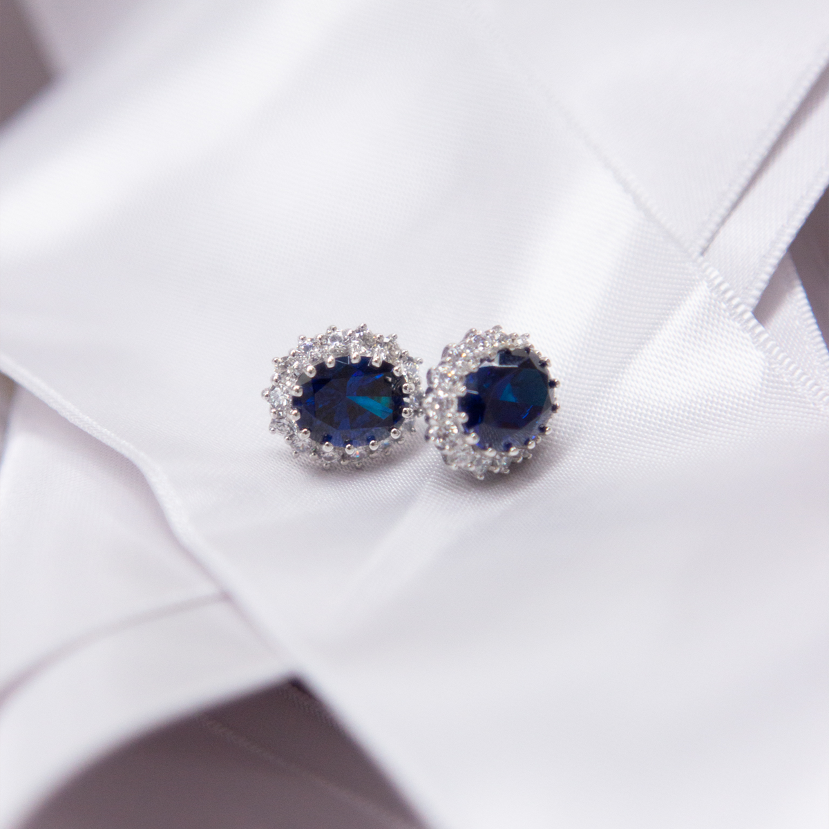 Sterling Silver Oval Shaped Blue Cubic Zirconia Cluster Stud Earrings on White Ribbon