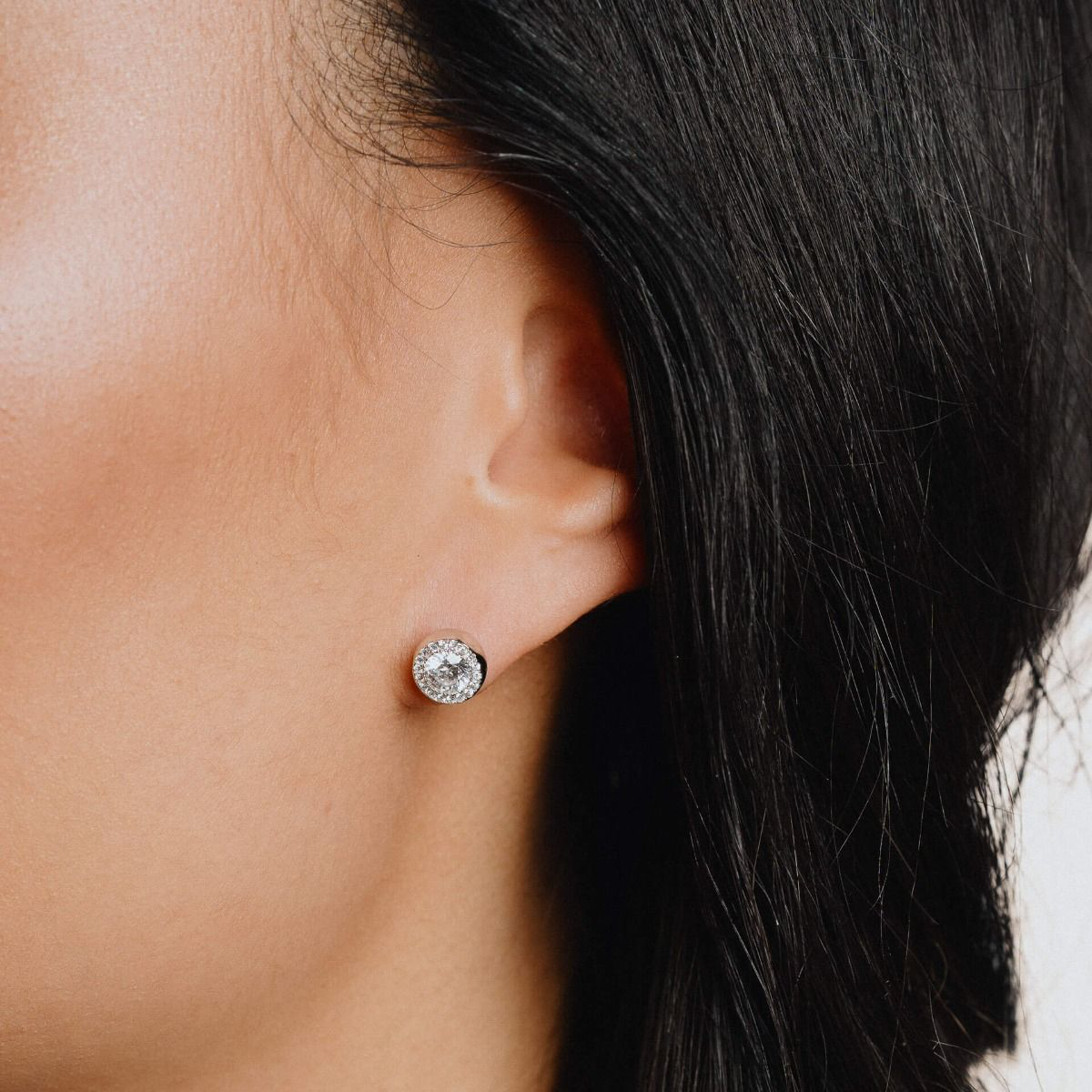Models wears Sterling Silver Round Cubic Zirconia Halo Stud Earrings