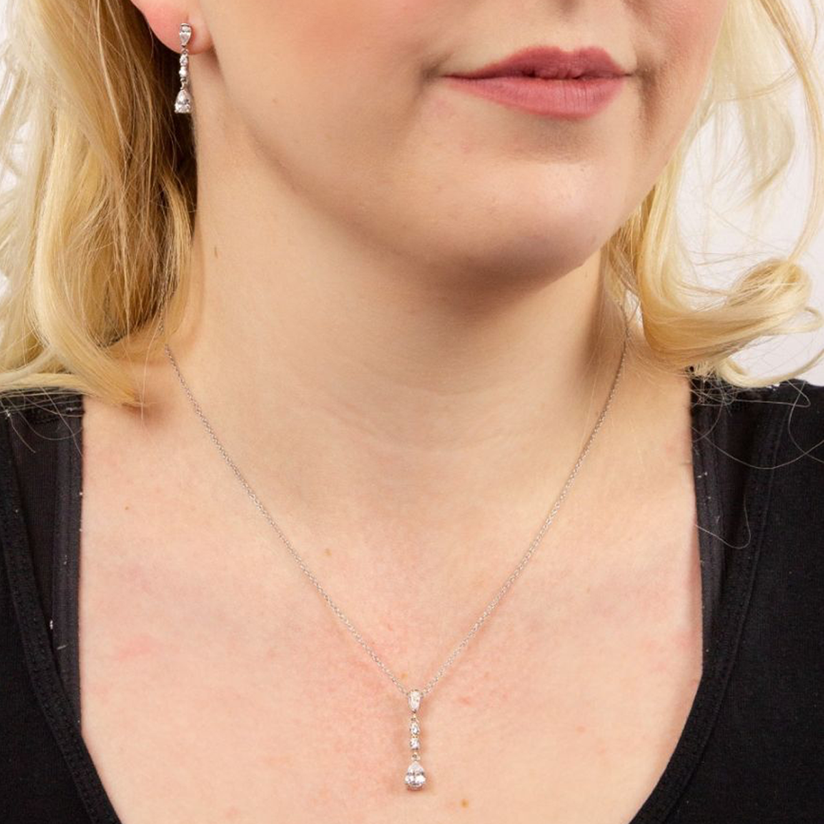 Model wears Long Teardrop Cubic Zirconia Pendant & Earrings
