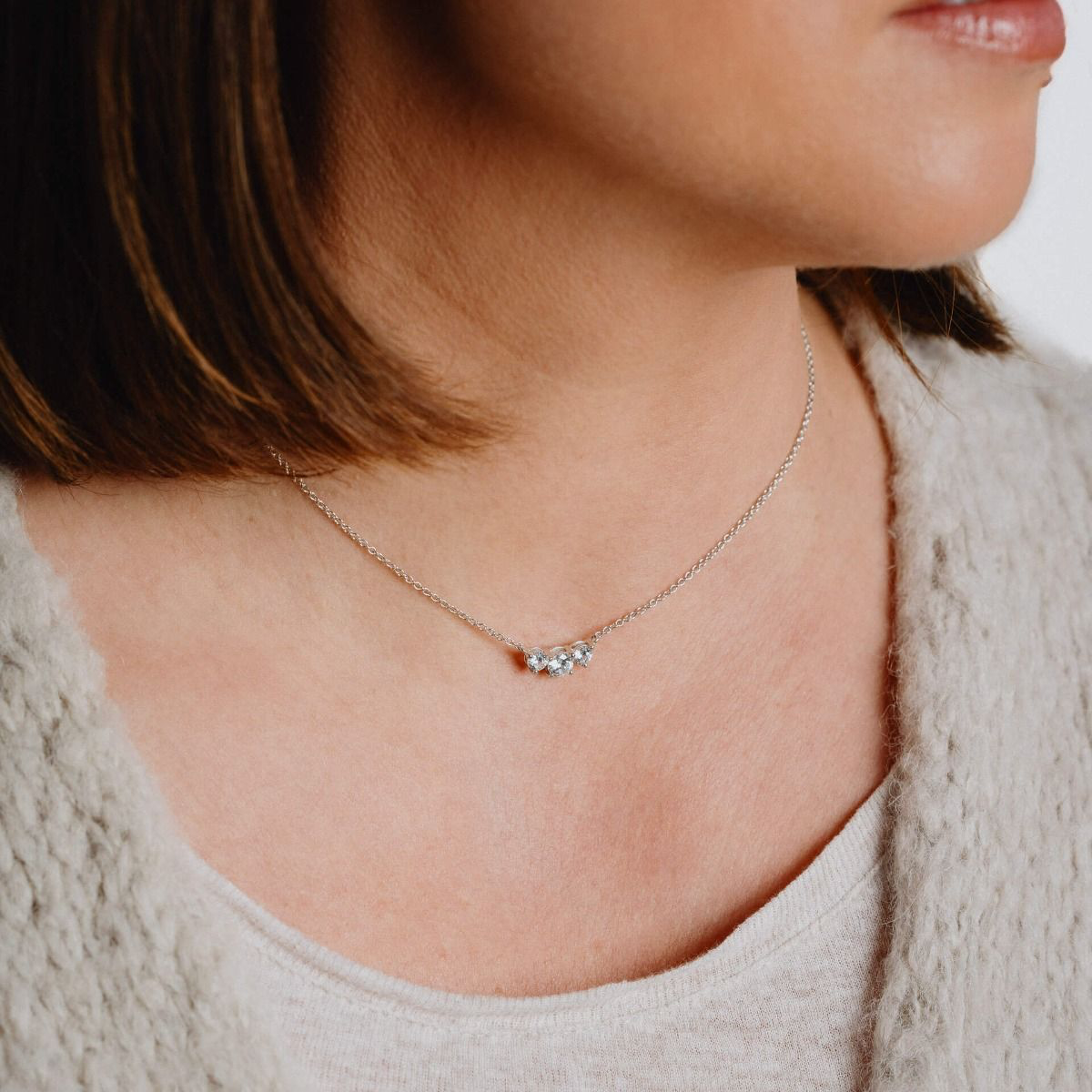Model wears Sterling Silver Cubic Zirconia Trilogy Necklace