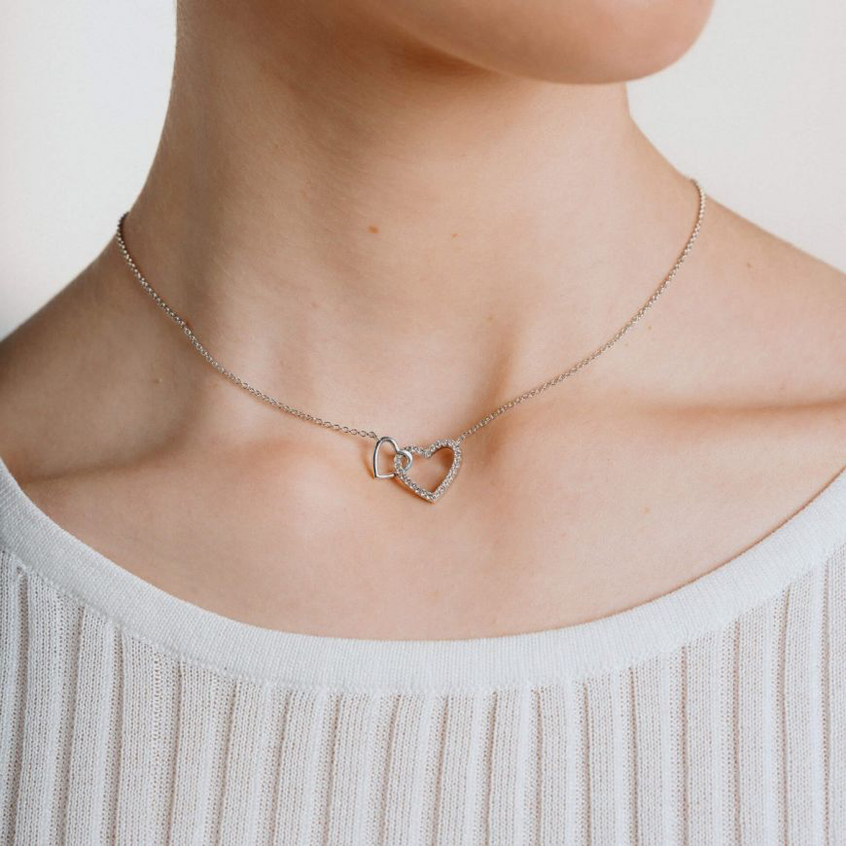 Model wears Sterling Silver Interlinked Hearts Cubic Zirconia Set Necklace