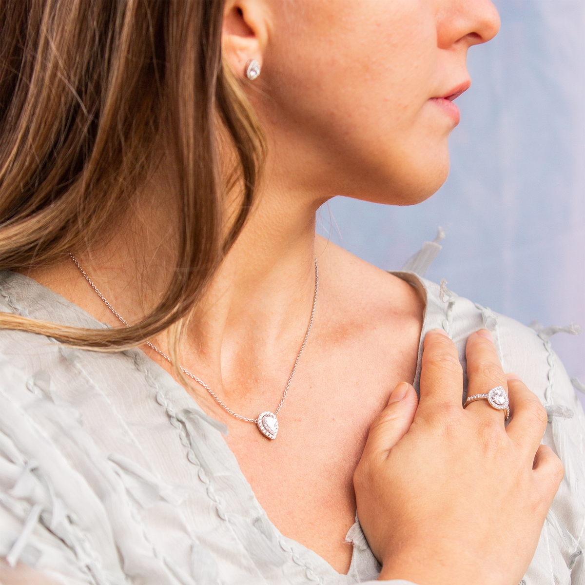 Model wears Sterling Silver Teardrop Cubic Zirconia Halo Jewellery Set