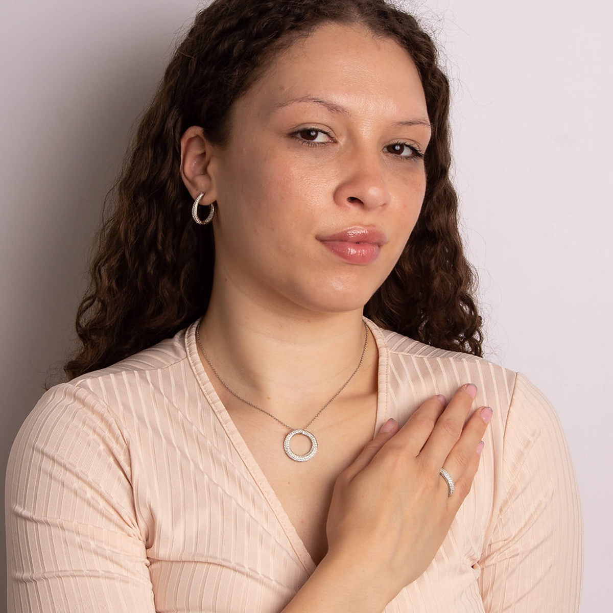 Model wears Sterling Silver Curly Hoop Cubic Zirconia Jewellery Set