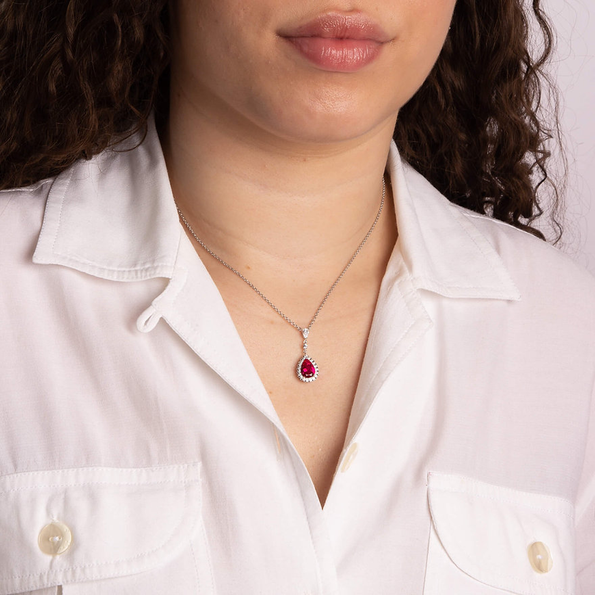 Model wears Sterling Silver Red Cubic Zirconia Teardrop with Pave Surround Necklace