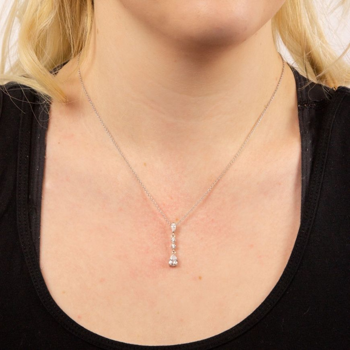 Model wears Sterling Silver Long Teardrop Cubic Zirconia Pendant