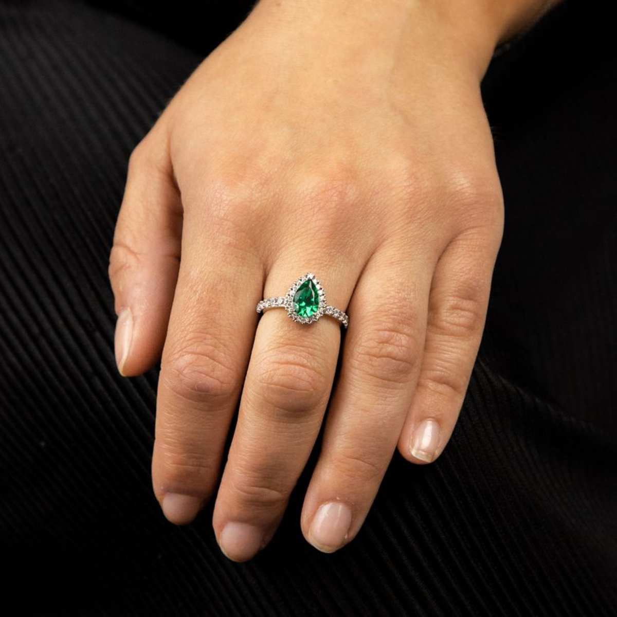Model hand wears Sterling Silver Teardrop Green Cubic Zirconia Halo & Shoulders Ring